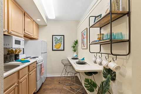 A kitchen with wooden cabinets and a white refrigerator.