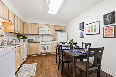 A kitchen with a table set for a meal.