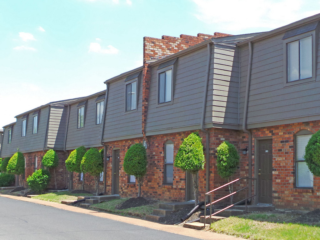 a row of houses with a street in front of them