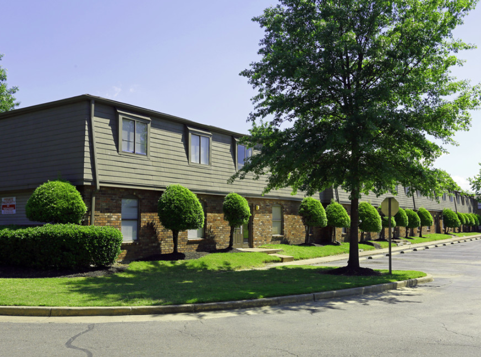 an apartment building with a street in front of it