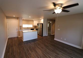 Kitchen with island and living room area l Brairwood Apartments in Livermore, CA 