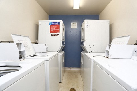 A laundry room with washers and dryers.