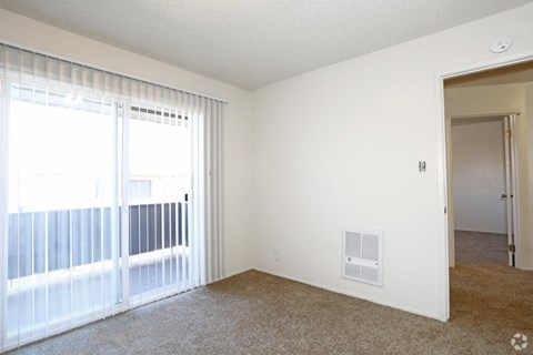 living room with patio l Marina Plaza Apartments in San Leandro CA
