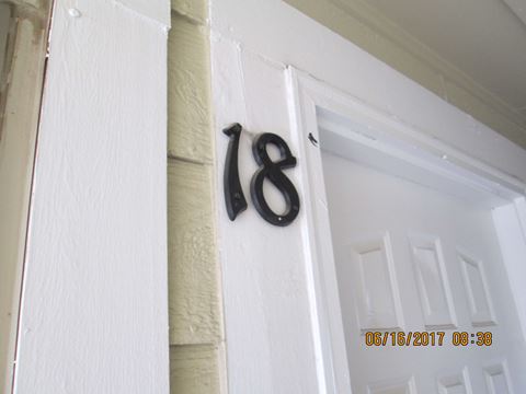 the house number on the wall next to the door