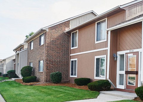 a brick building with a lawn in front of it