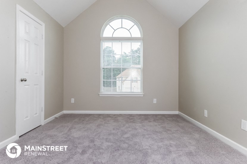the master bedroom with carpeted flooring and a large window