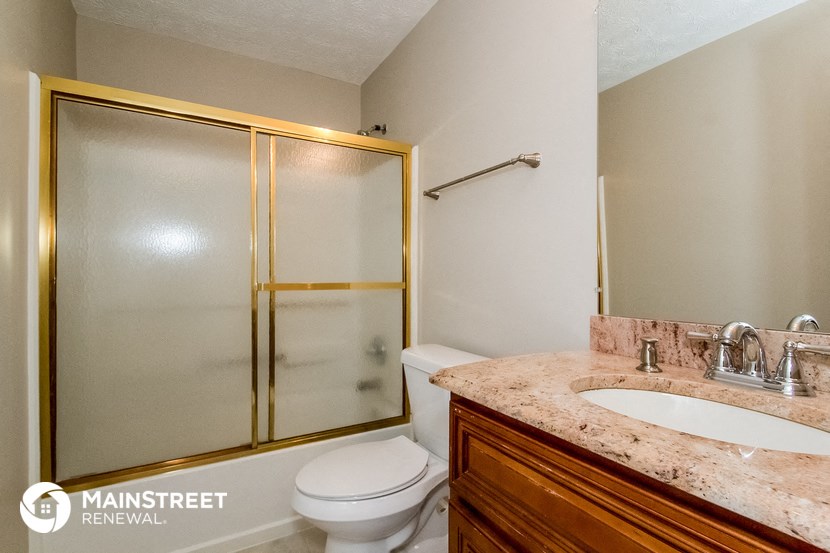 a bathroom with a shower toilet and sink