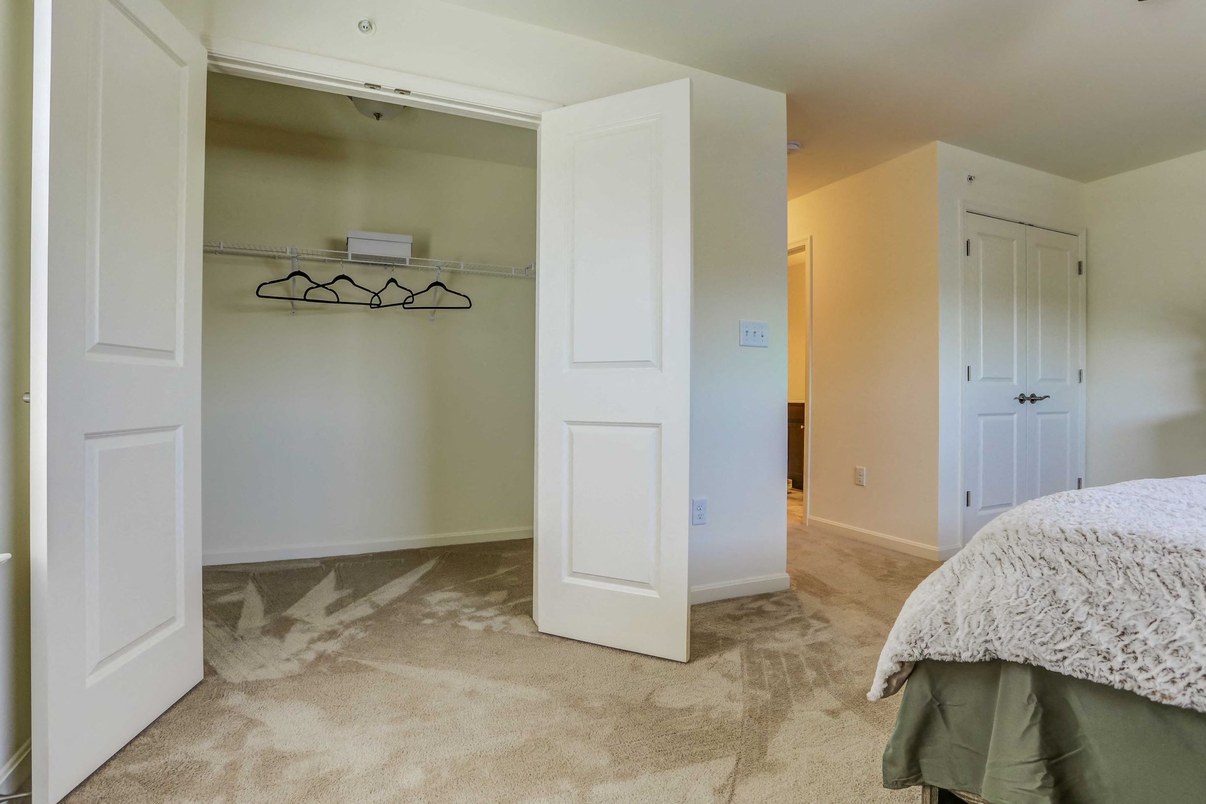 a bedroom with a closet and a bed and an open closet