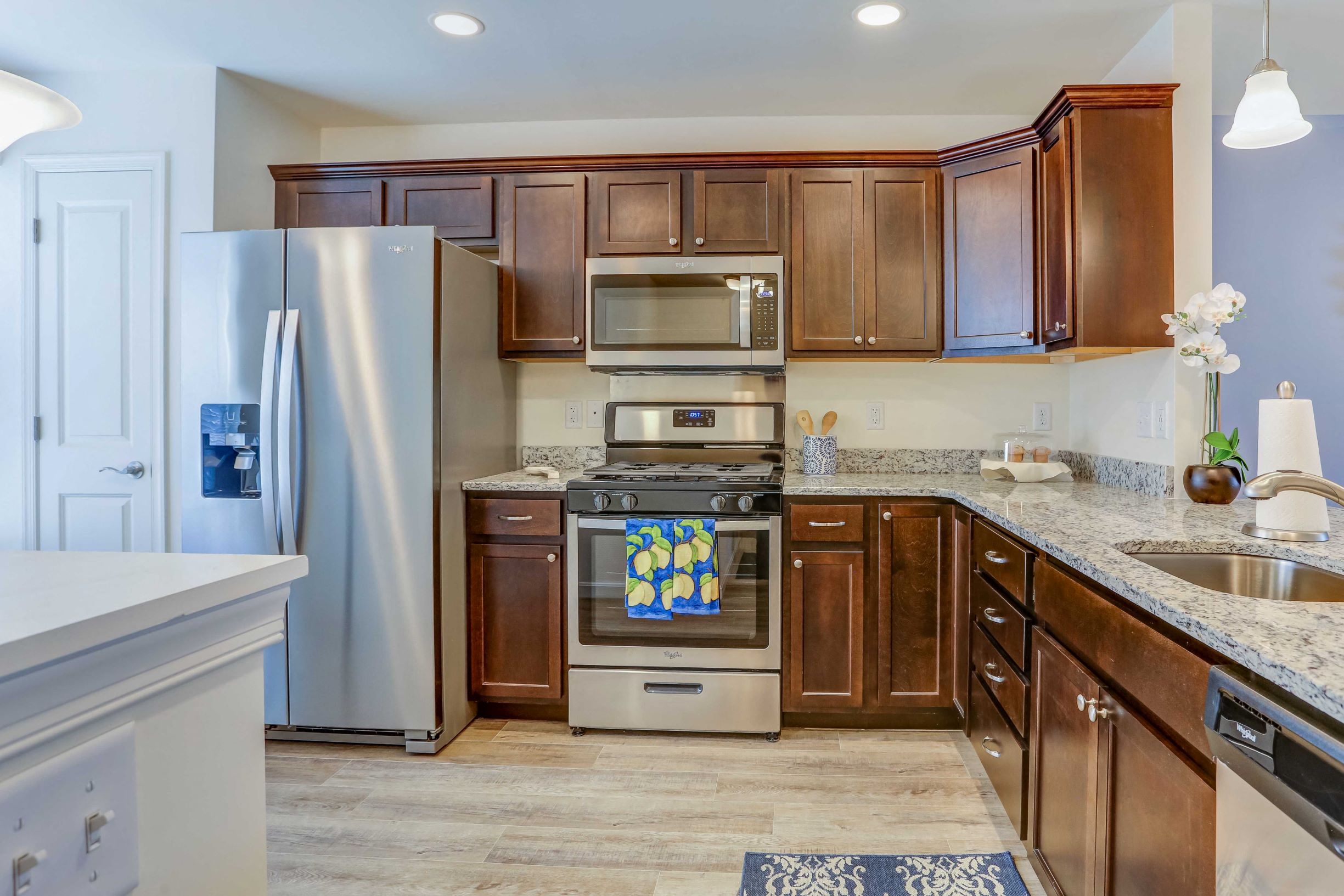 a kitchen with stainless steel appliances and wooden cabinets