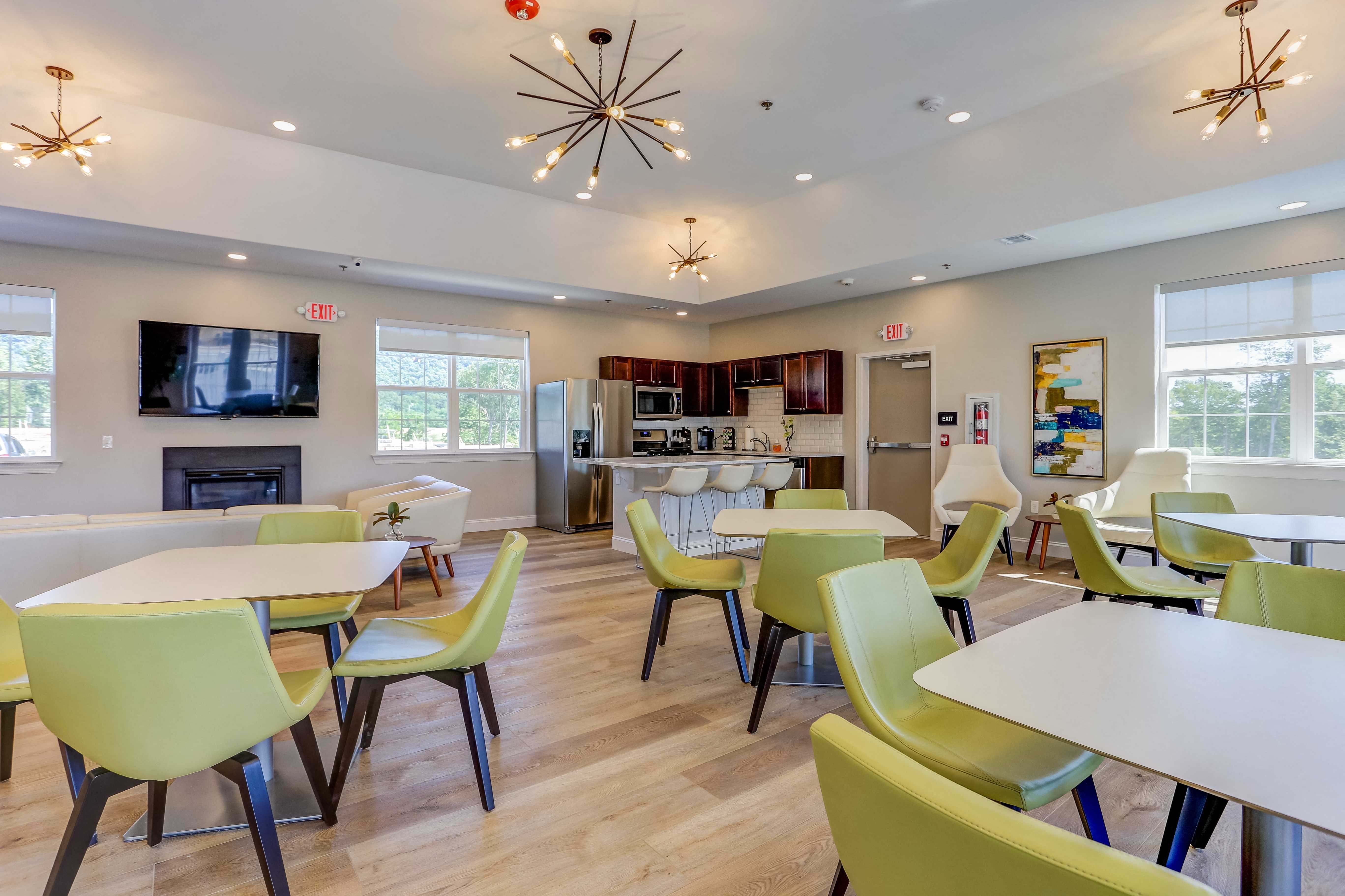 a dining room with tables and chairs and a fireplace