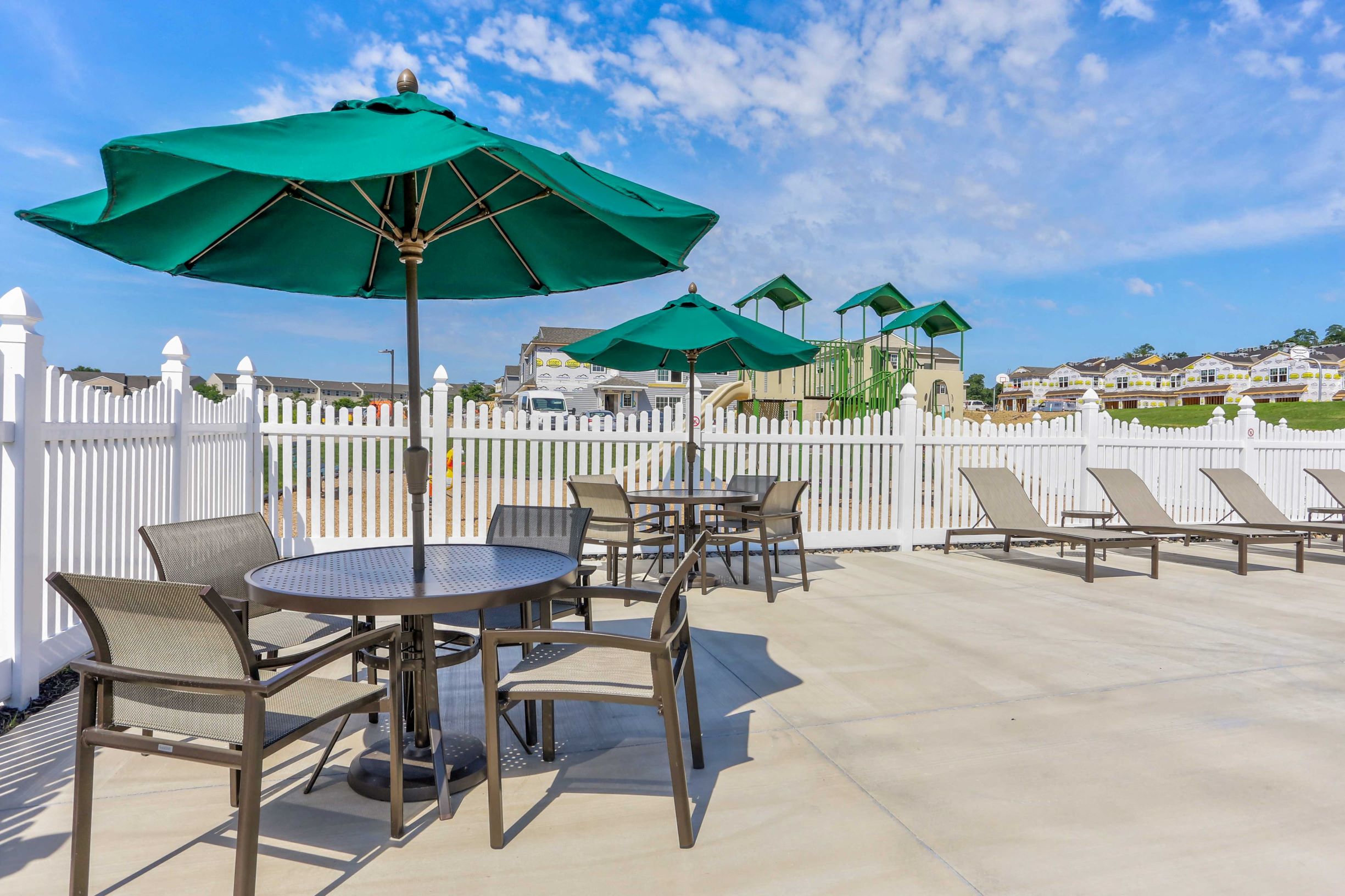 a patio with tables and chairs and umbrellas