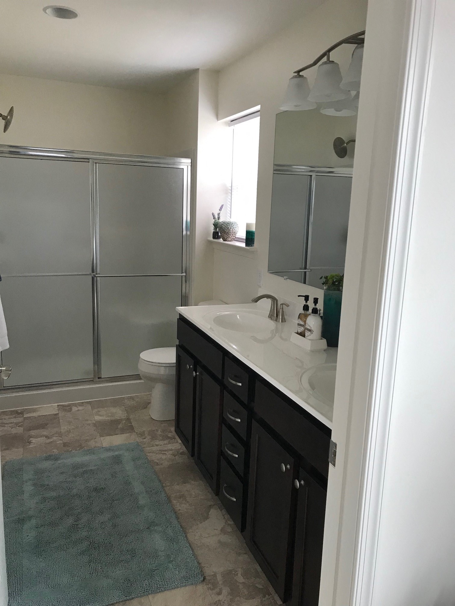 a bathroom with a sink and a shower and a toilet
