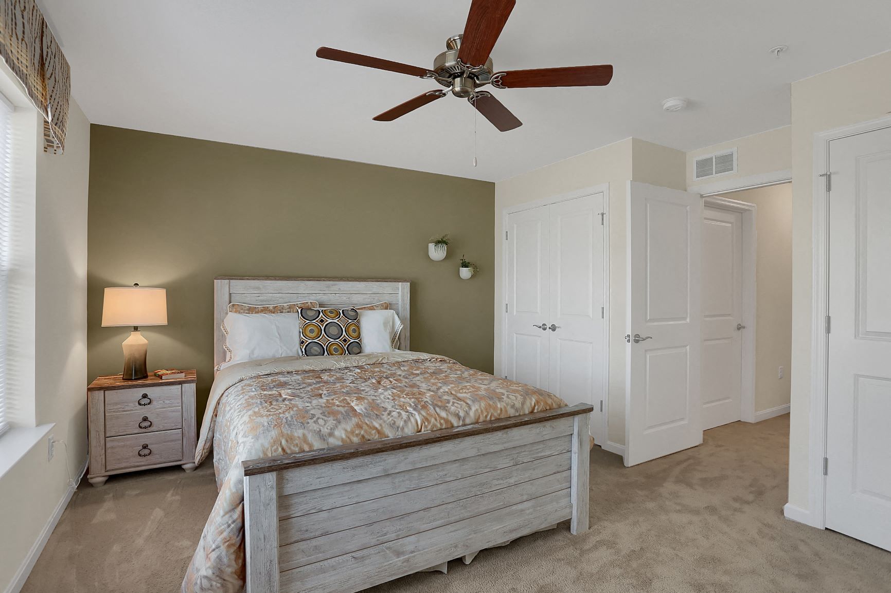 a bedroom with a bed and a ceiling fan