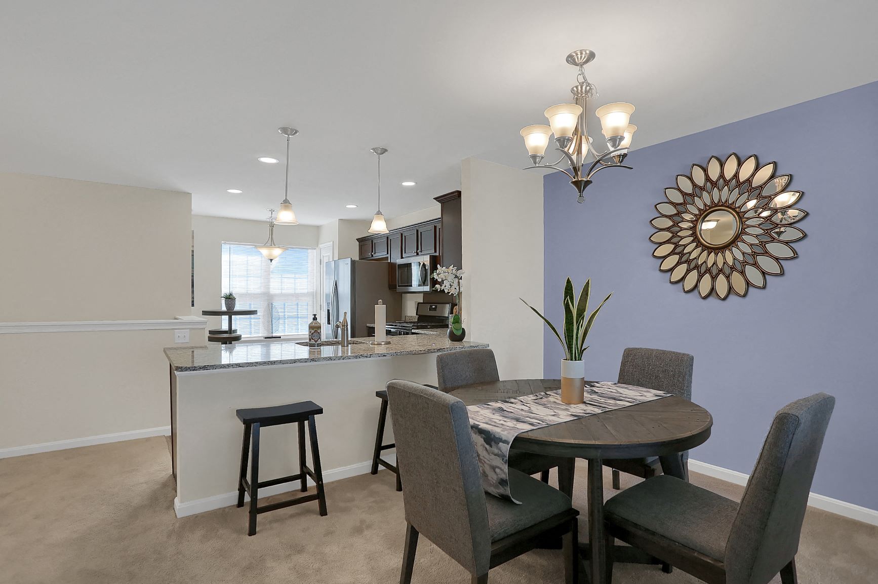 a dining room and kitchen with a table and chairs