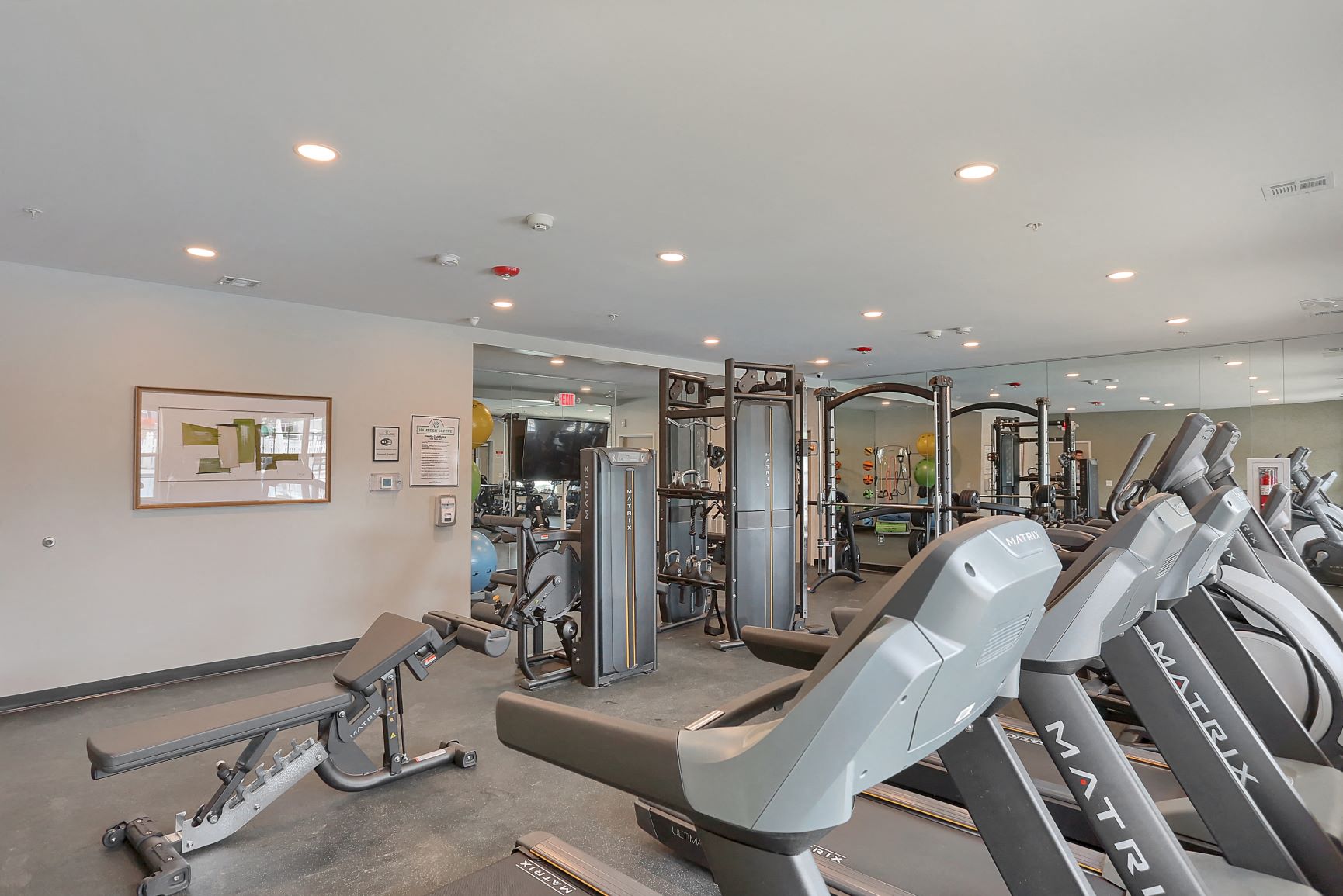 a gym with treadmills and other exercise equipment