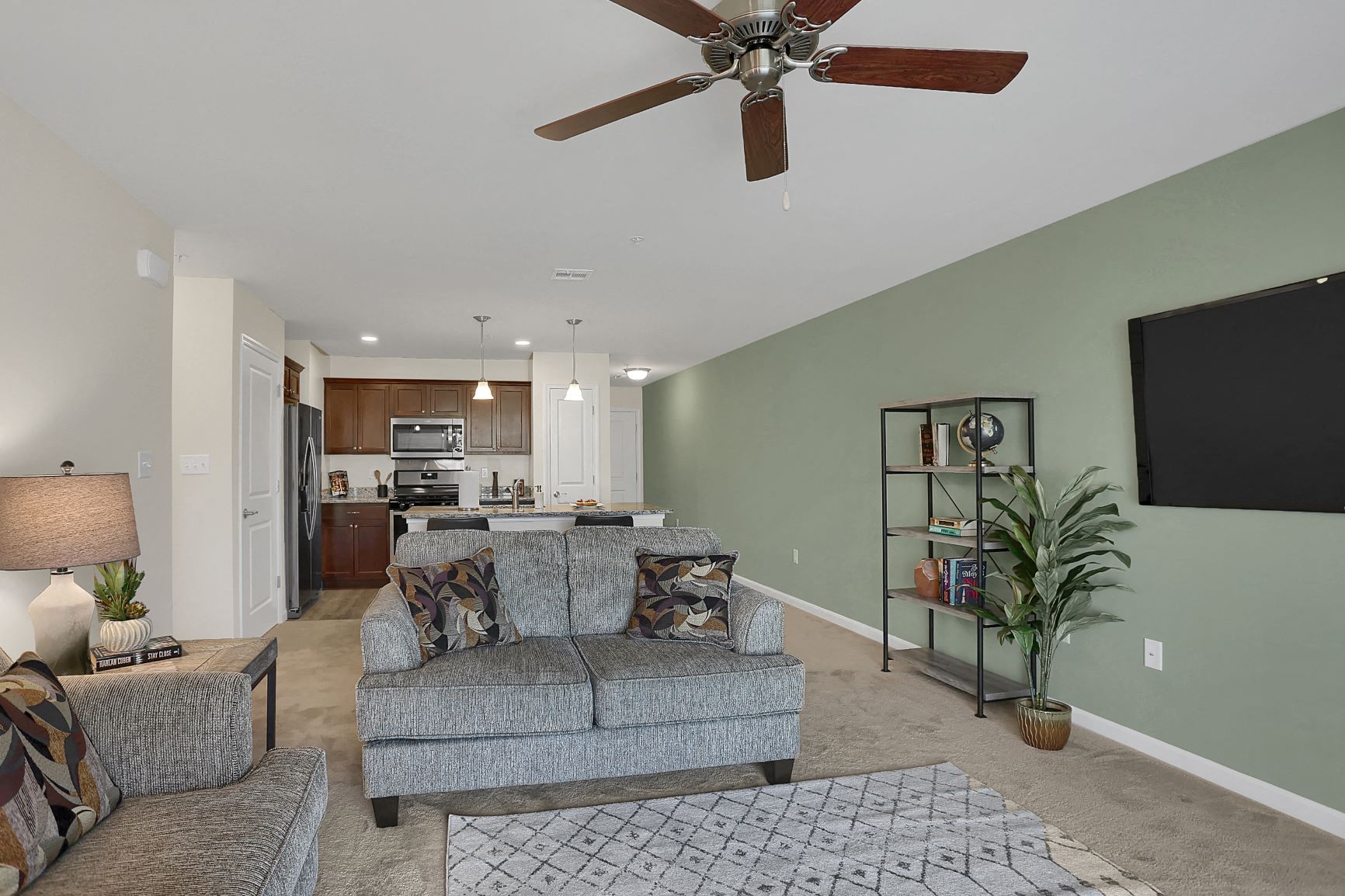 a living room with a couch and a ceiling fan