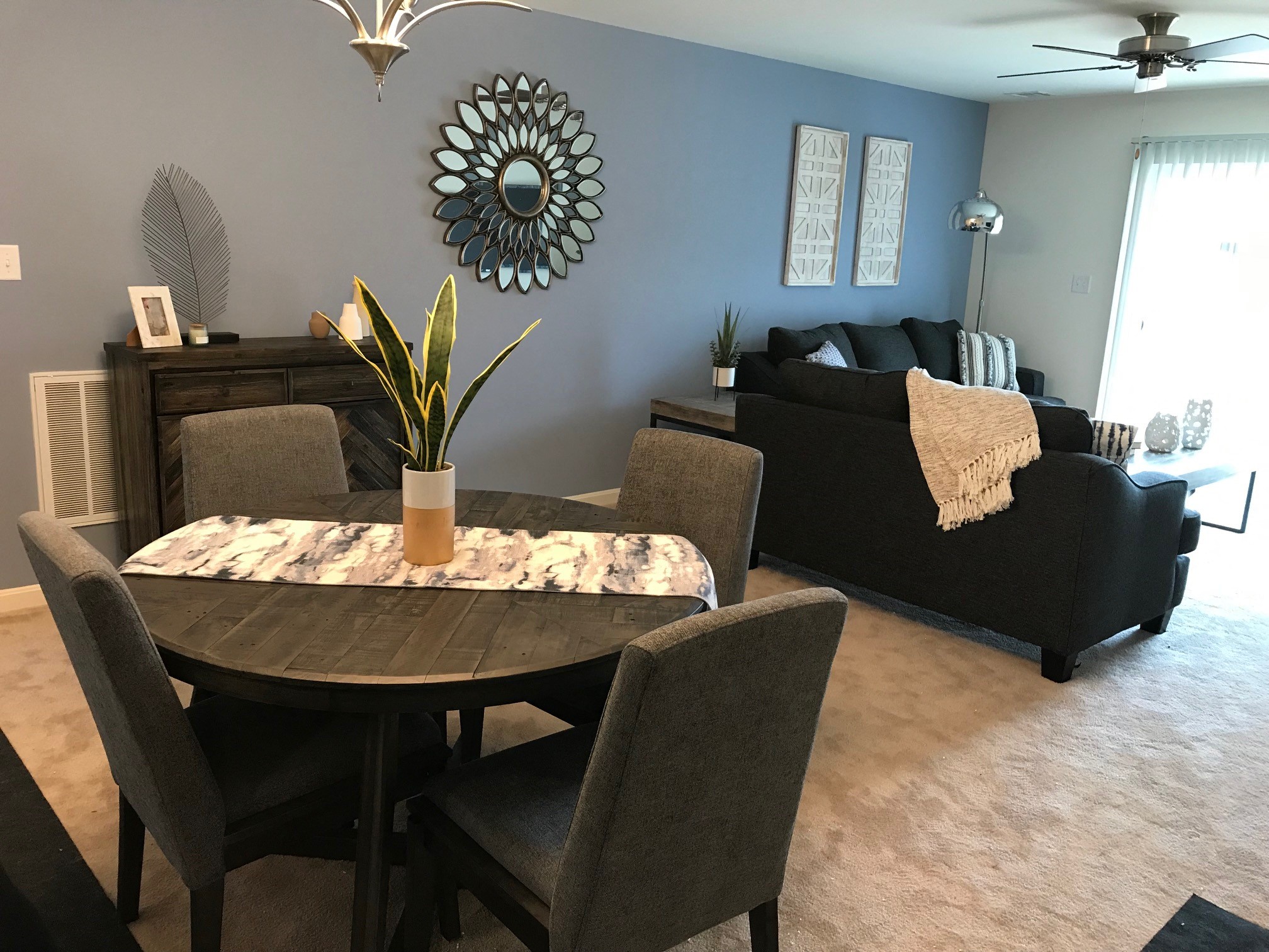 a dining room and living room with a couch and a table