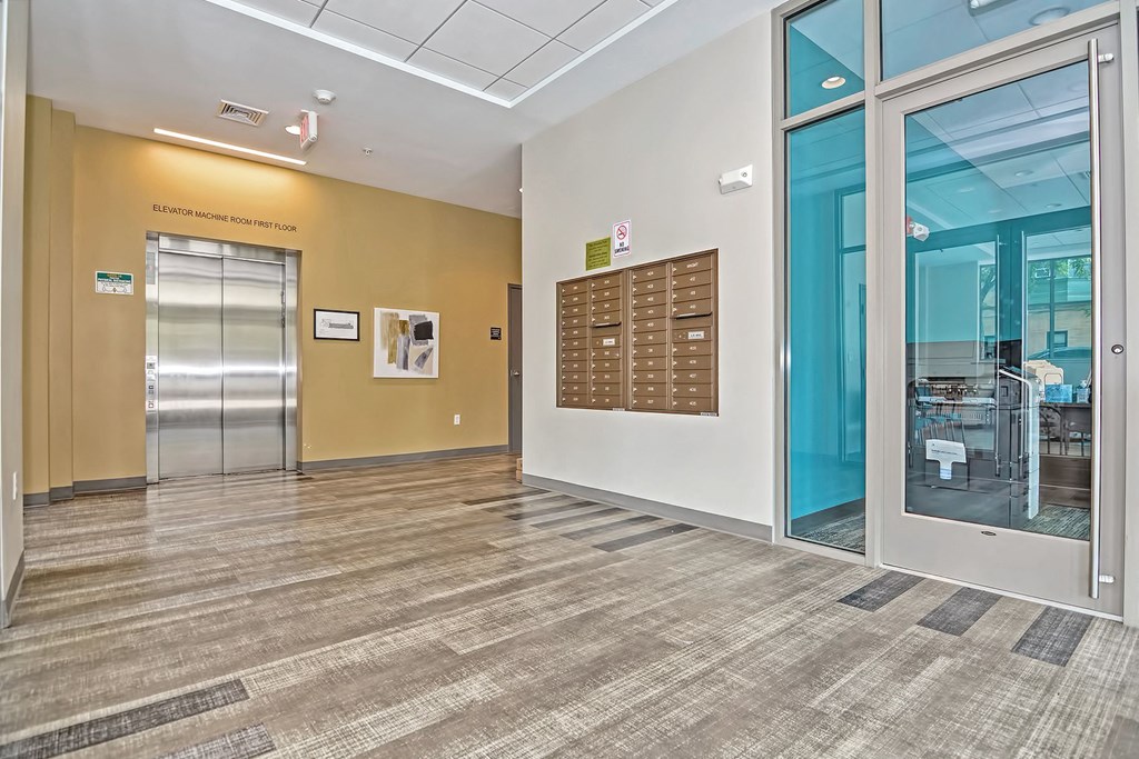 the lobby of a building with glass doors and a vending machine