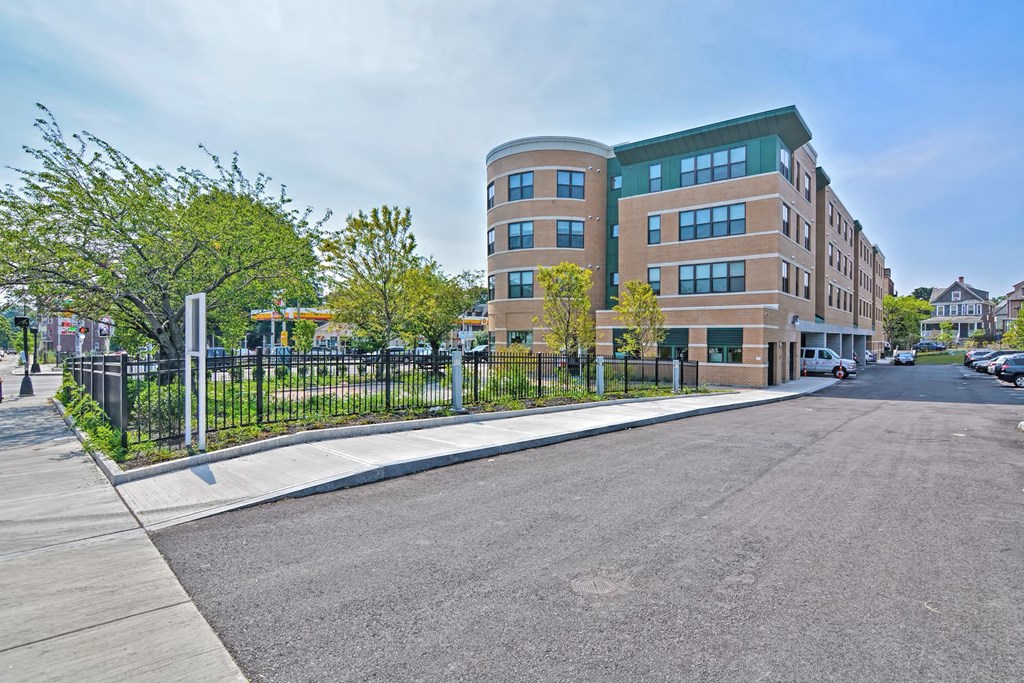an empty street with a building in the background