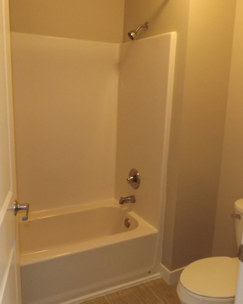 a small bathroom with a tub and a toilet