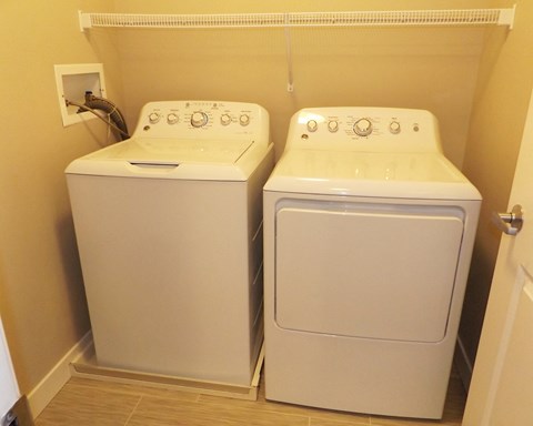 a washing machine and a washer and dryer in a room
