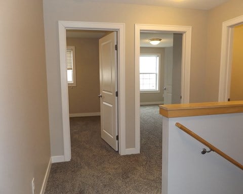 a view of the hallway from the bottom of the stairs looking into the living room