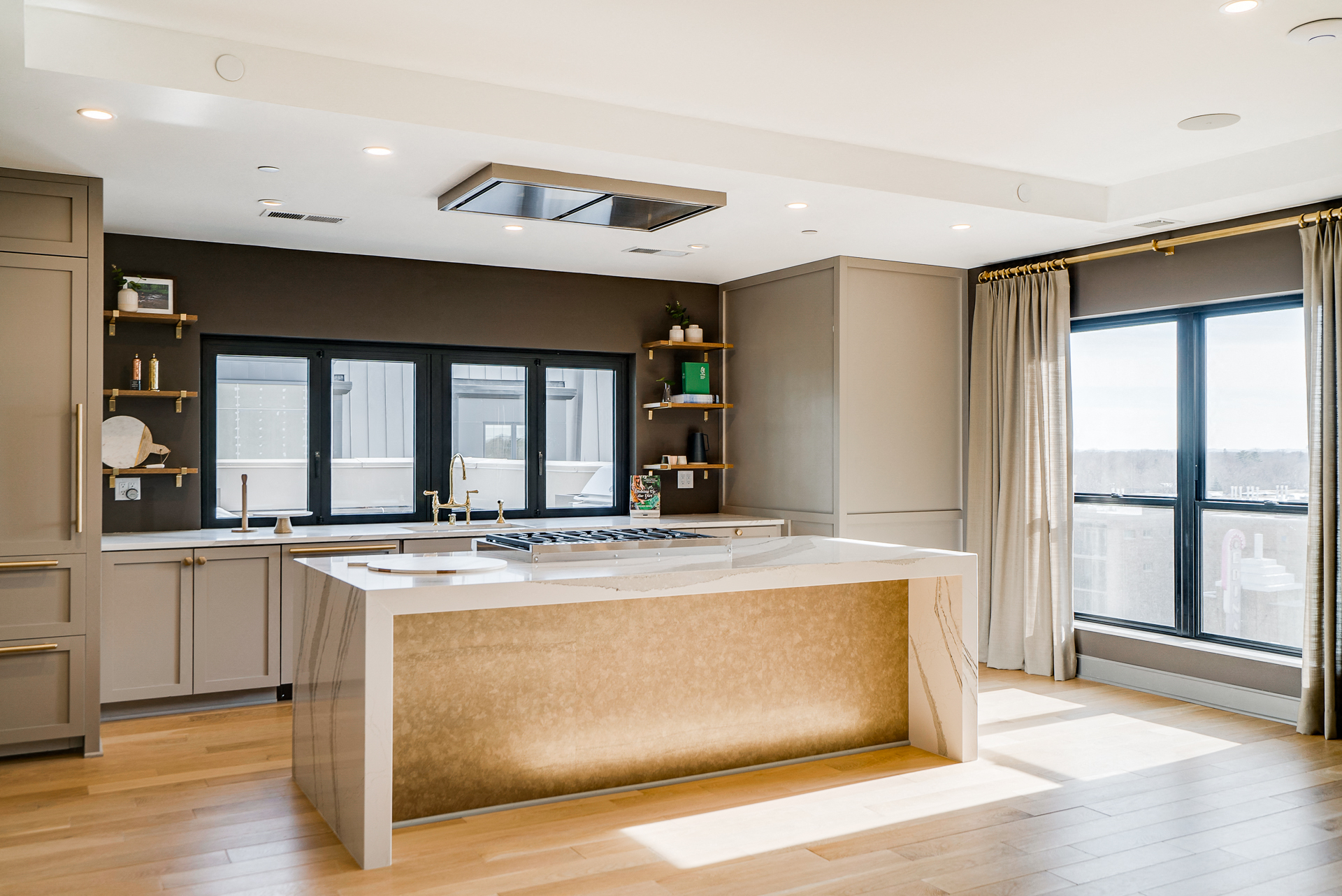 a large kitchen with a large island and windows