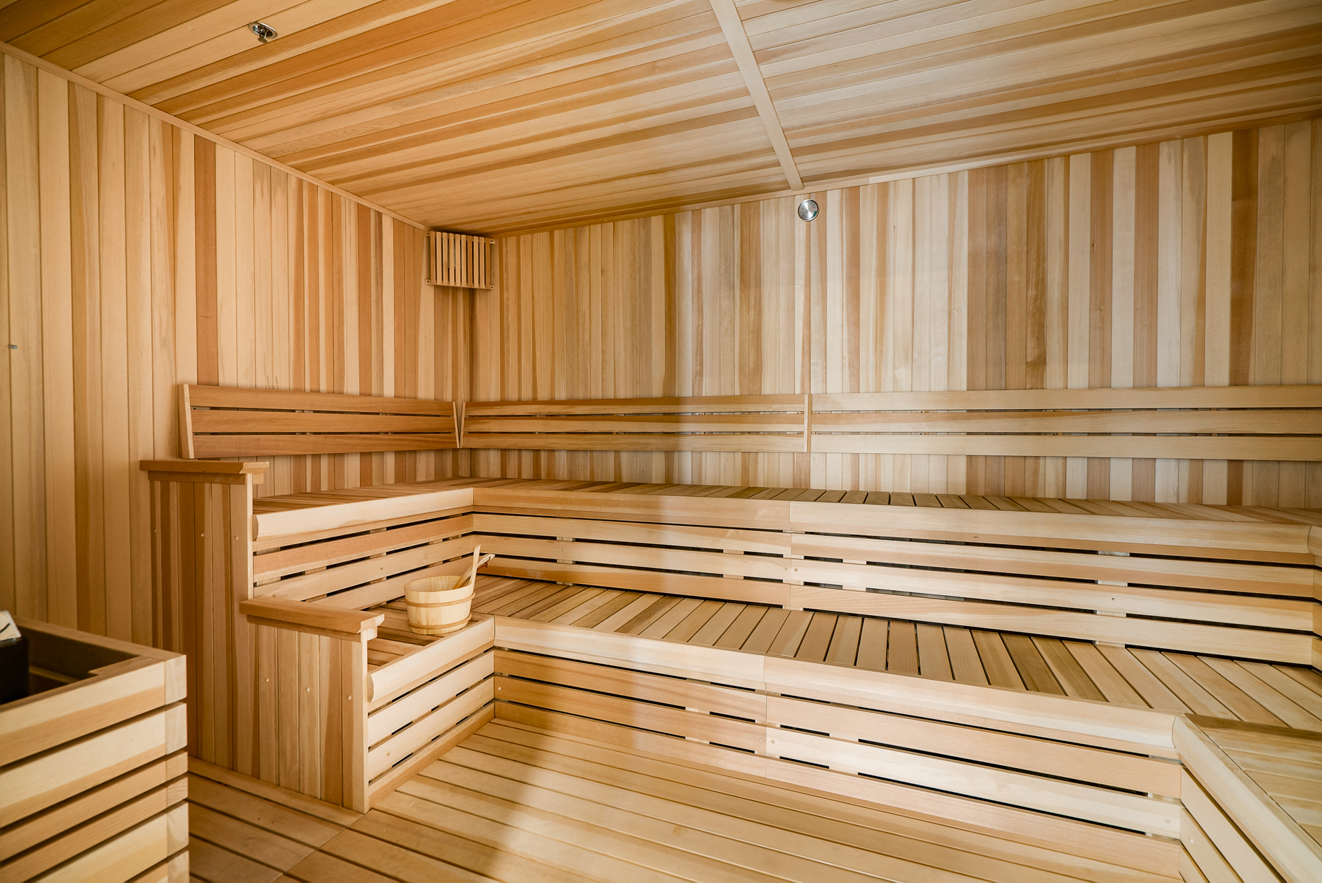 a sauna in a wooden room with wooden benches