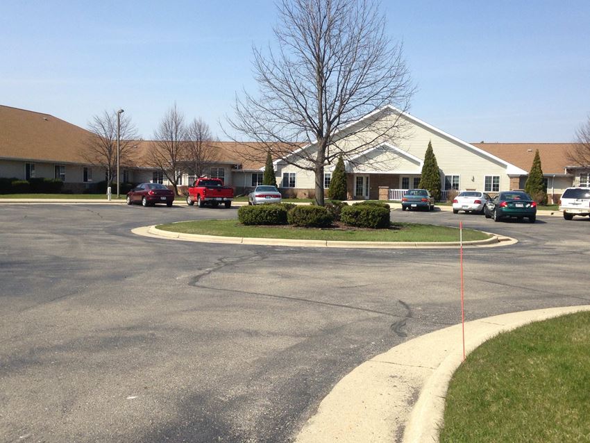 a parking lot with cars in front of a house