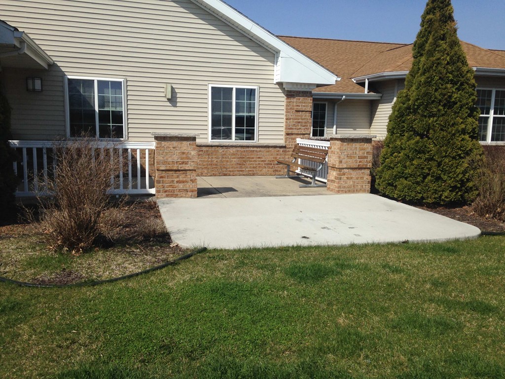 a concrete patio in front of a house