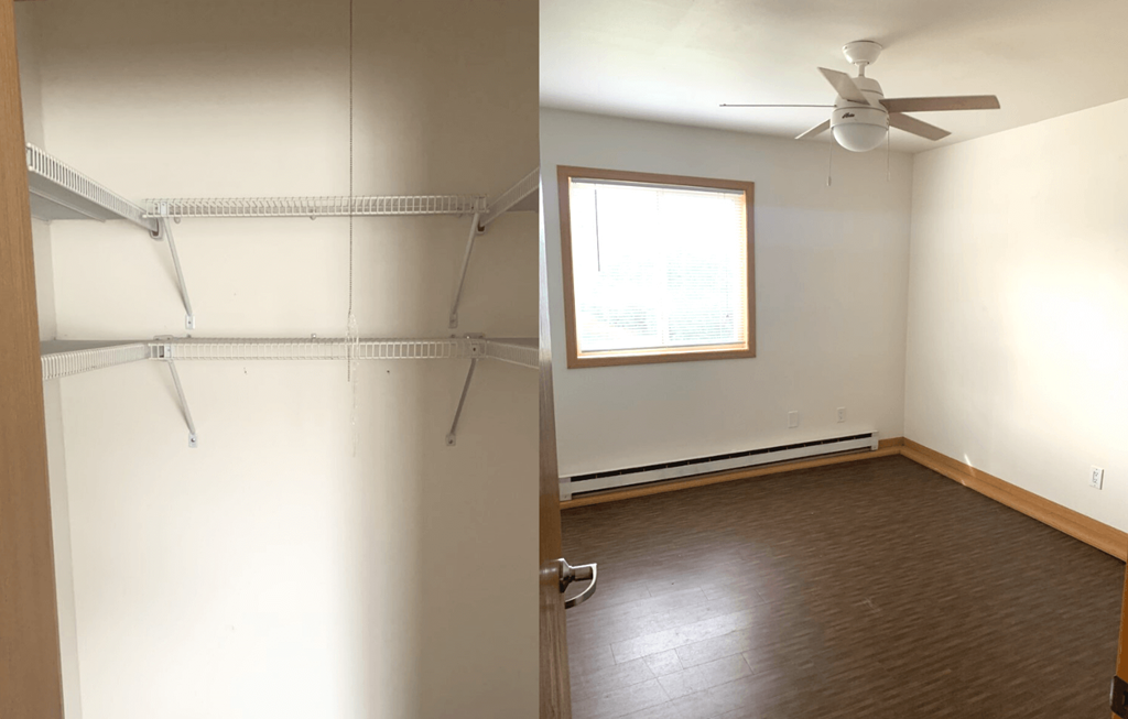 an empty room with a closet and a window