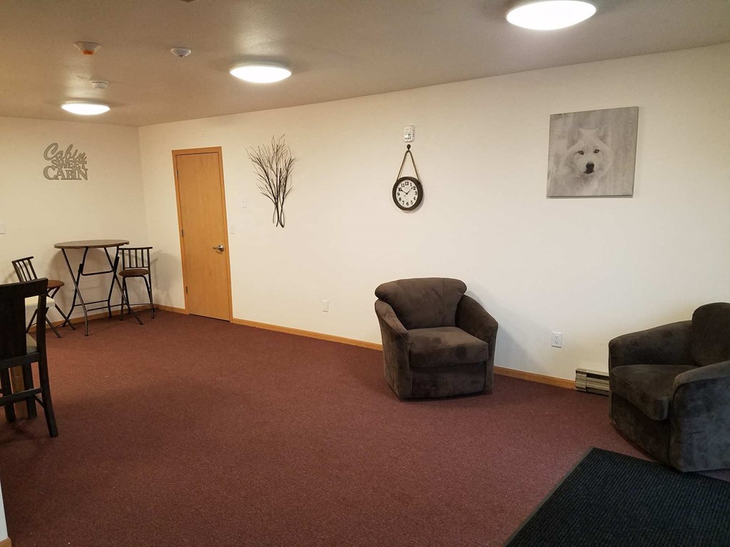 a living room with two chairs and a table