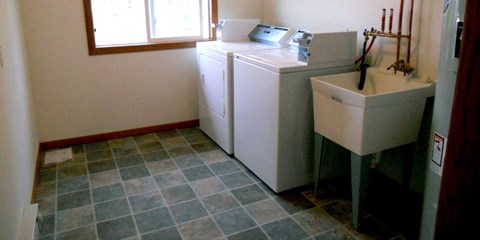 the laundry room has a washer and dryer and a sink