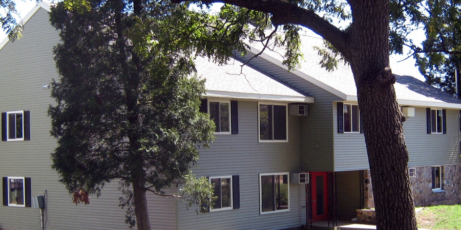 a white house with a tree in front of it