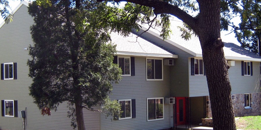 a white house with a tree in front of it