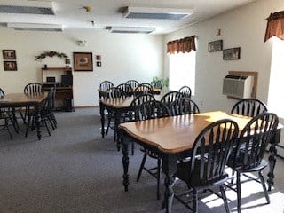 A room with a long table and chairs.
