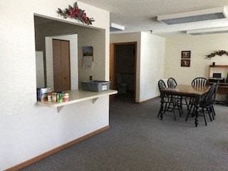 A kitchen with a table and chairs.