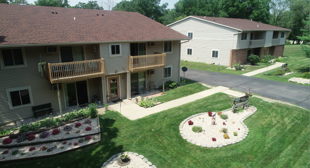 an aerial view of a house with a yard and a driveway