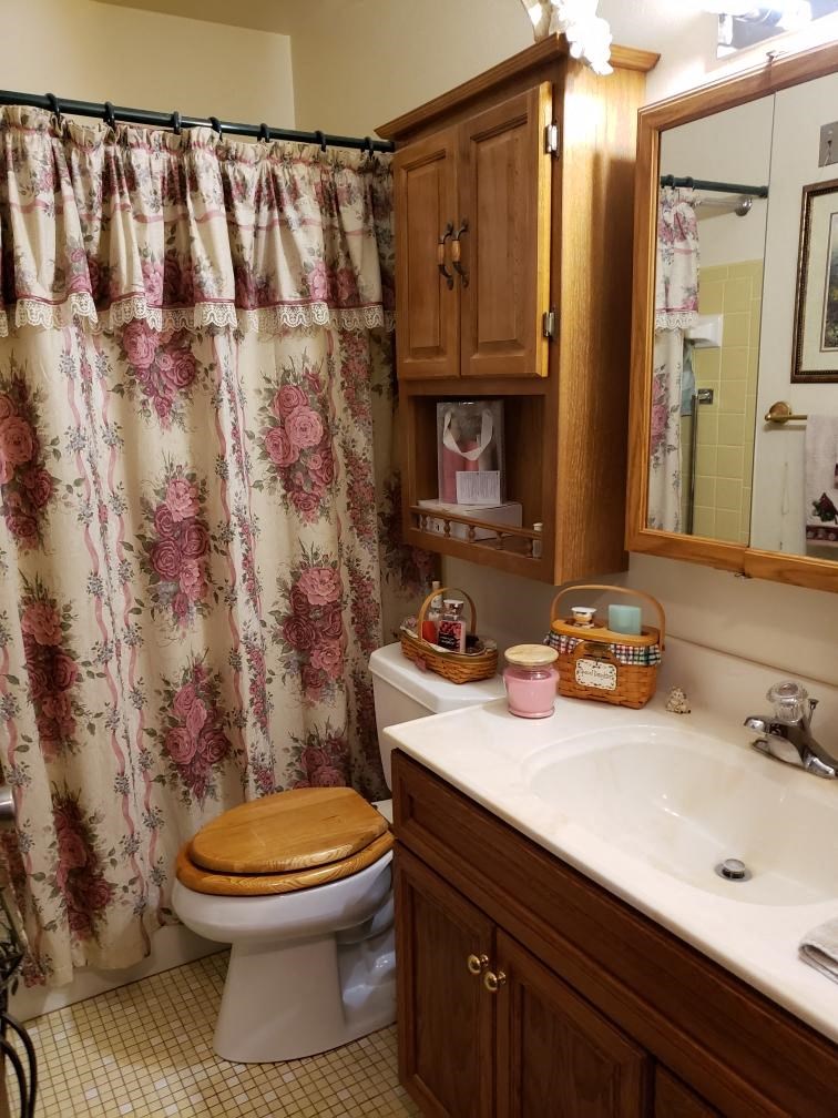 a bathroom with a toilet and a sink and a shower
