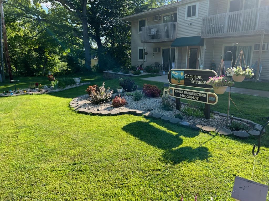 a yard with a sign in front of a house