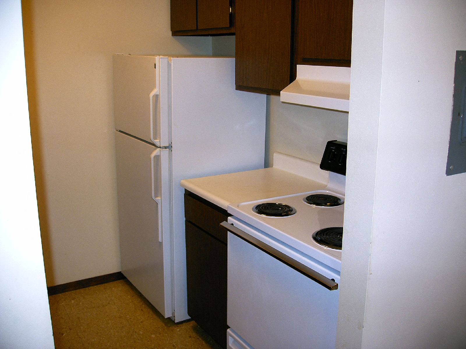 a kitchen with a stove and a refrigerator