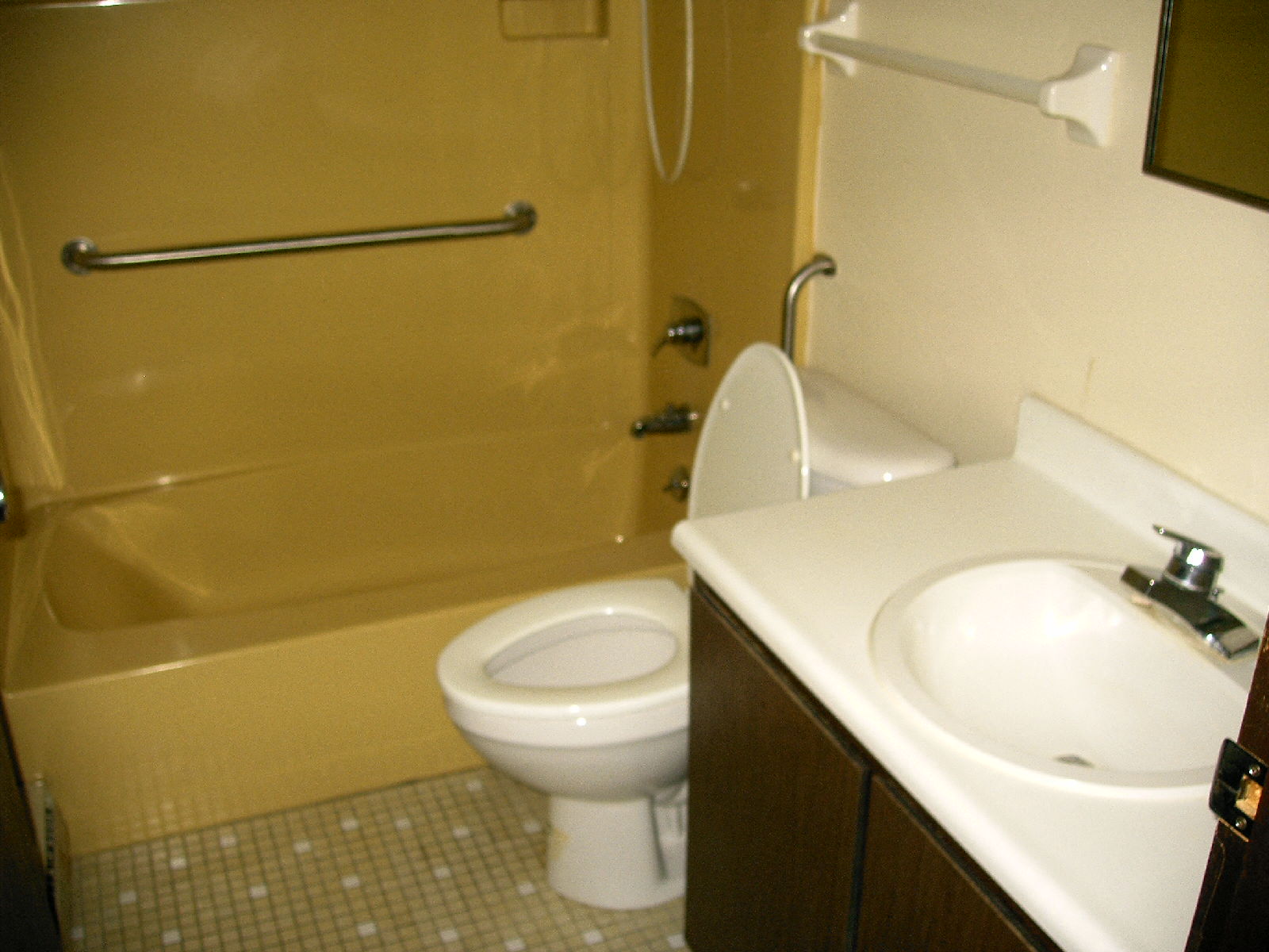 a bathroom with a toilet and a sink and a shower