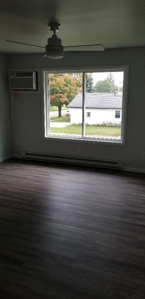 an empty living room with a large window