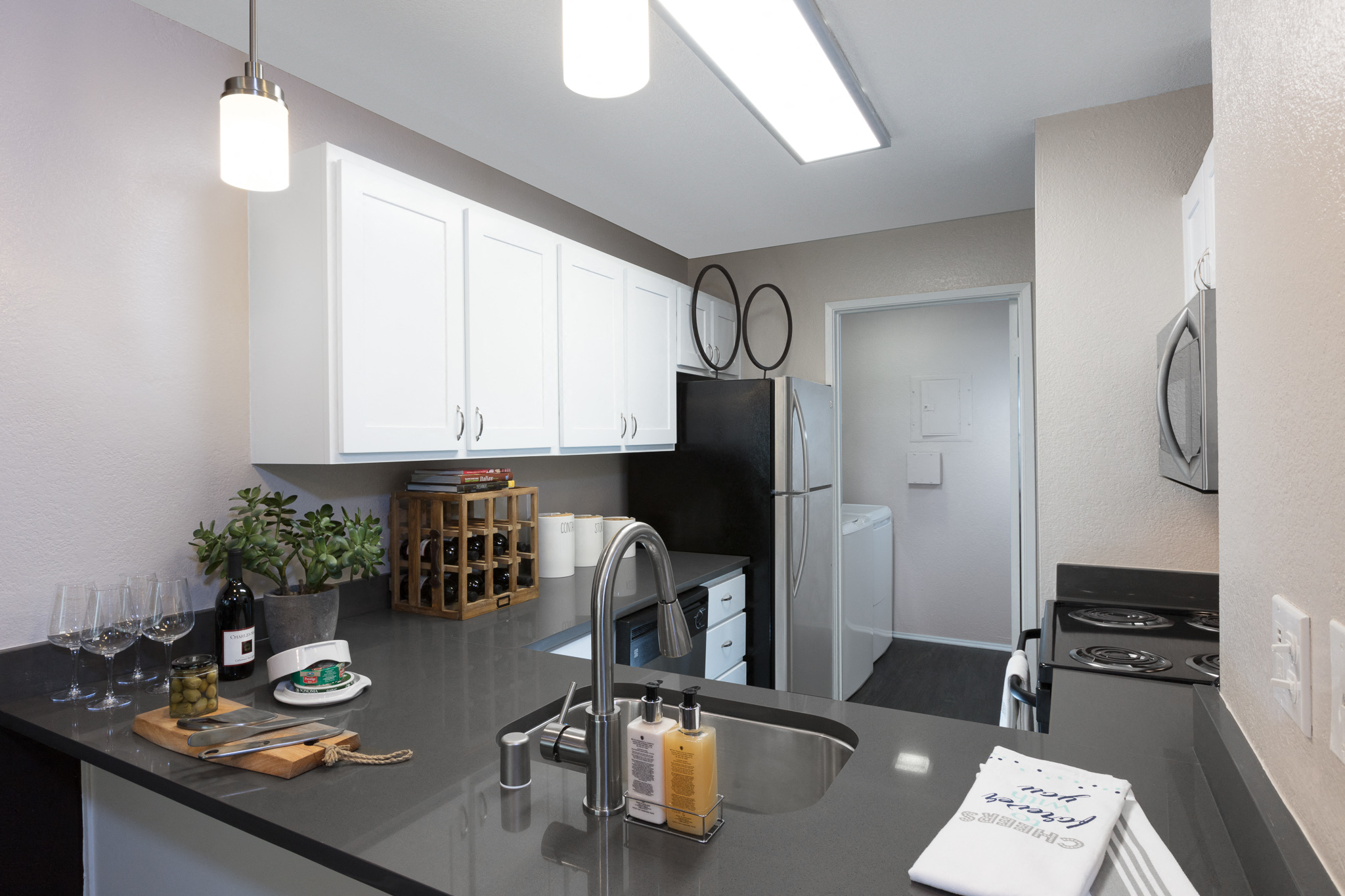 a kitchen with a counter top and a sink and a refrigerator