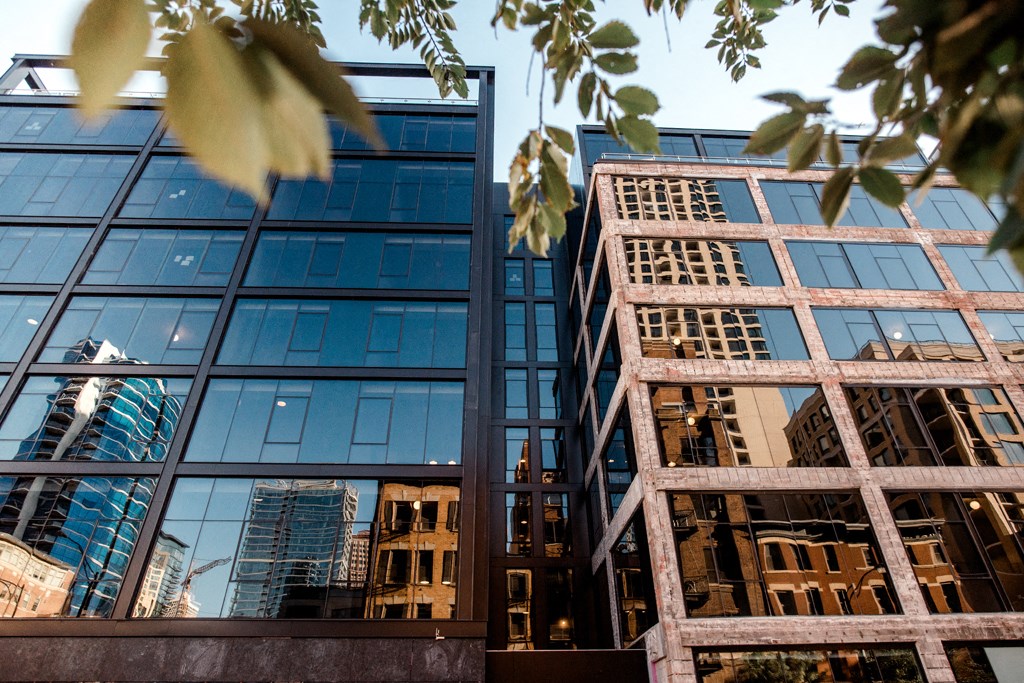 the reflection of skyscrapers in a glass building