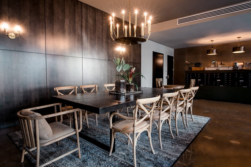 a dining room with a long table and chairs and a chandelier