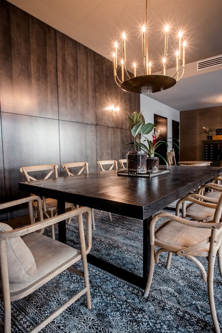 a dining room with a long wooden table and chairs