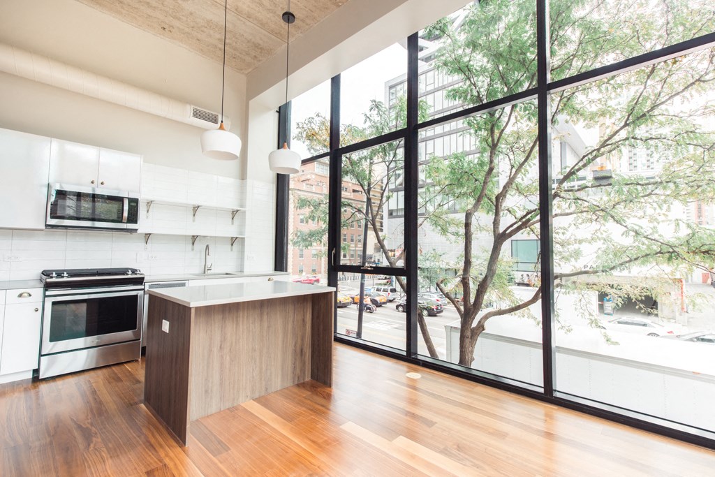a kitchen with a large window and a counter top in front of it