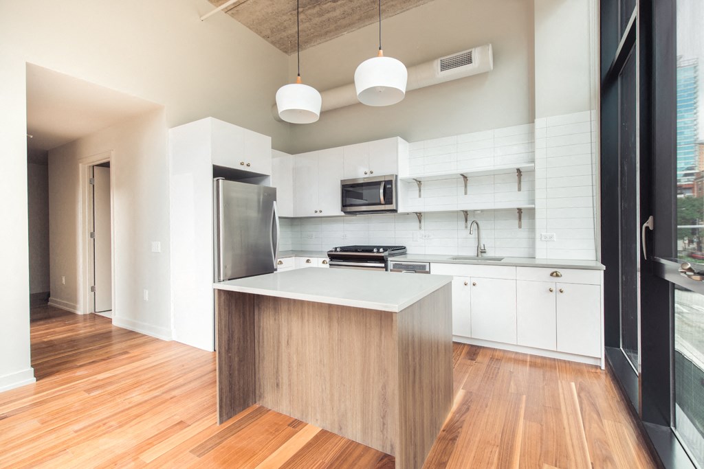 a kitchen with white cabinets and a white counter top