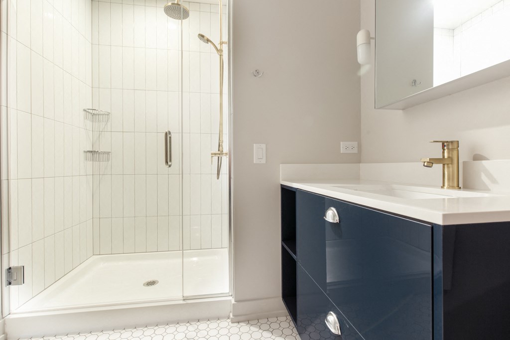 a small bathroom with a sink and a shower